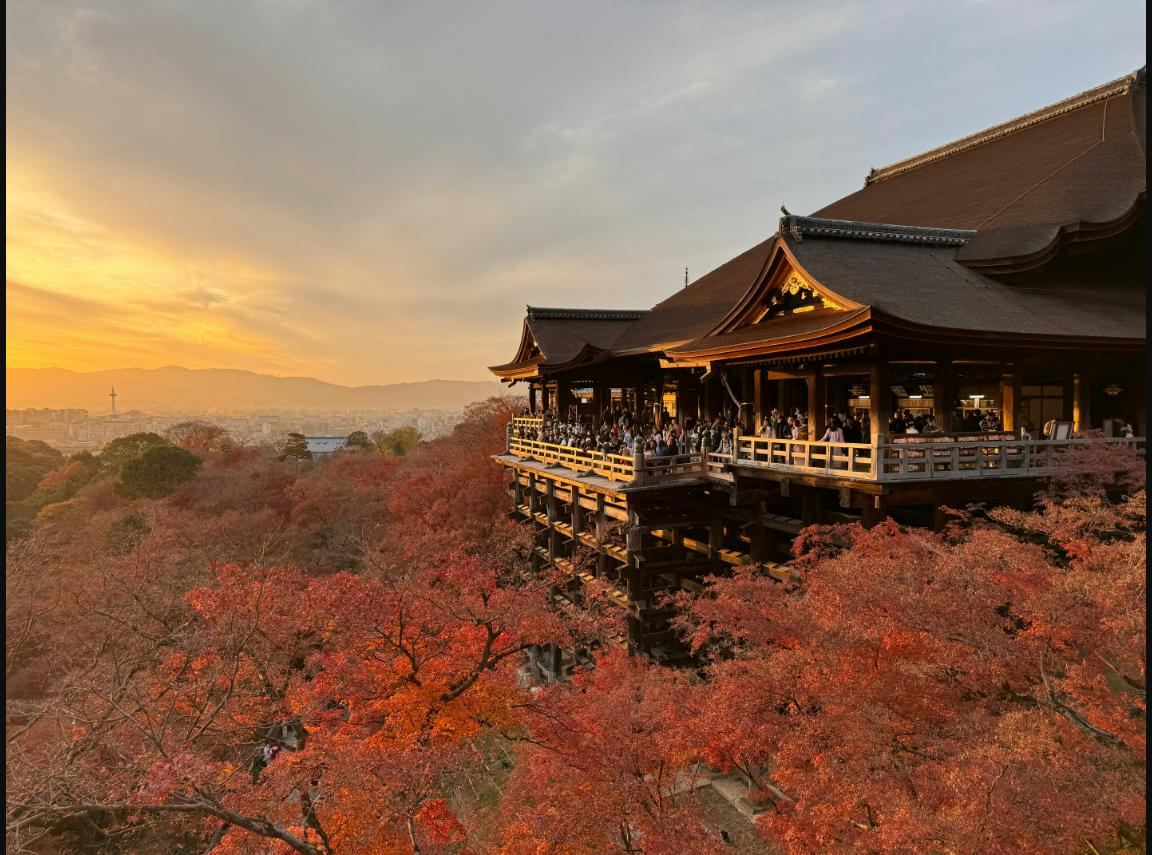 Kiyomizu-dera temple at sunset, surrounded by autumn foliage, Kyoto