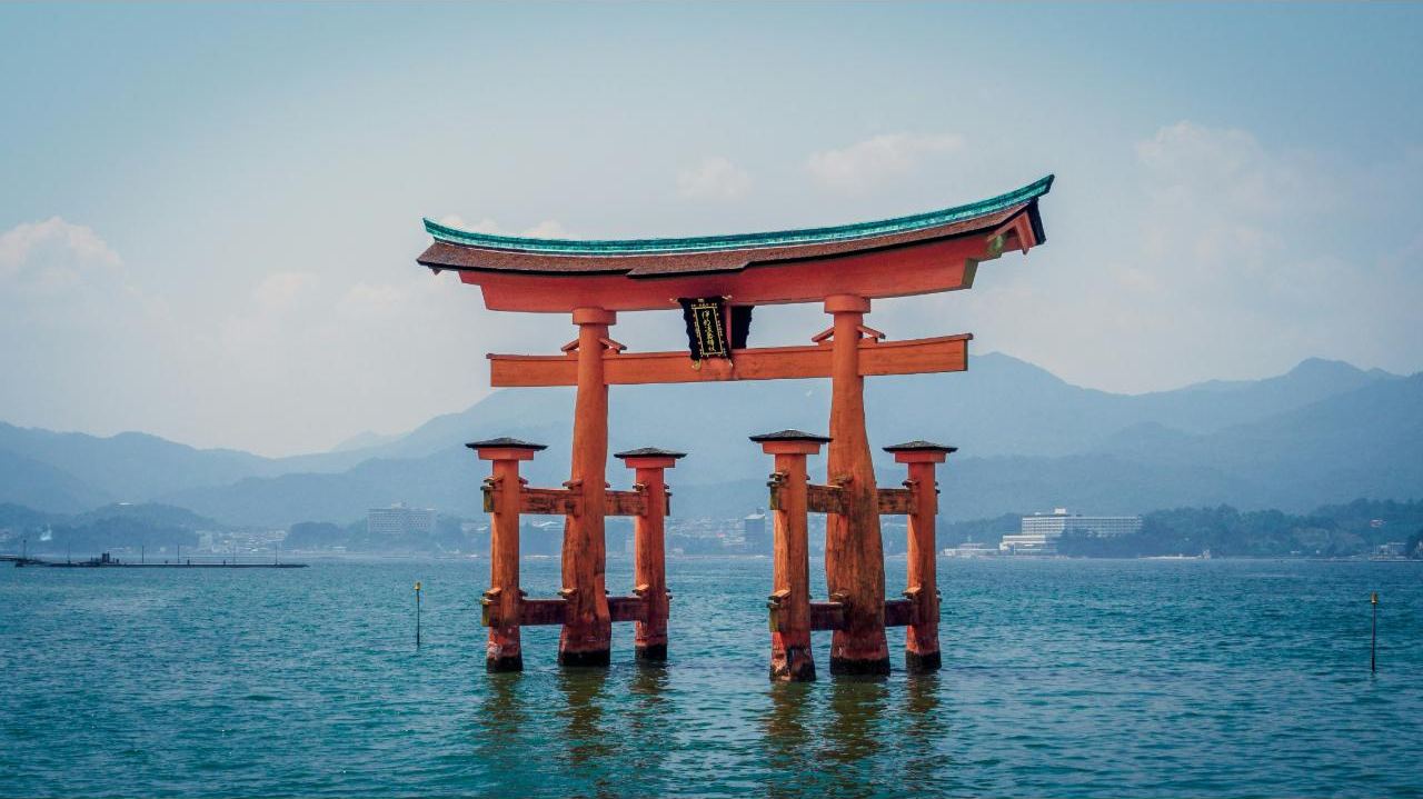 The vermilion floating torii gate of Itsukushima Shrine standing in the sea at high tide, Miyajima, Hiroshima